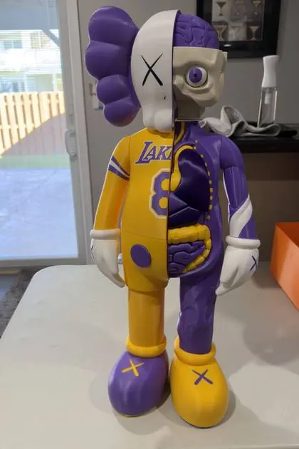 The 3D printed Lakers KAWS figure photographed on a table