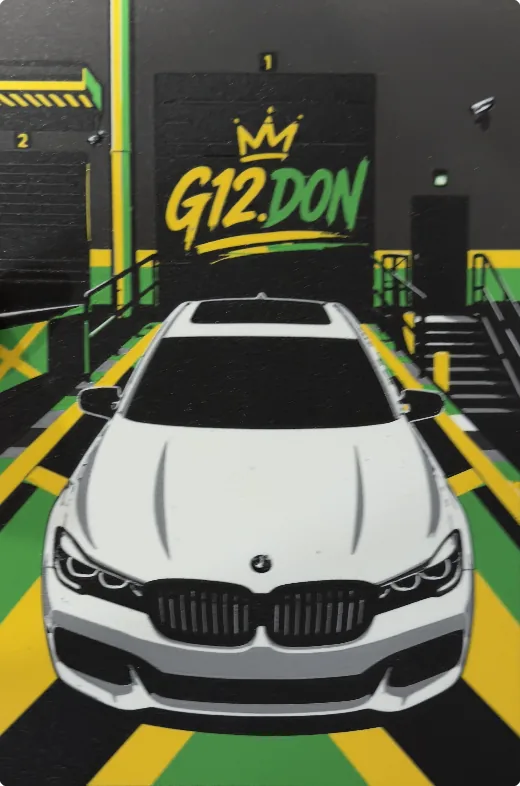 A flat printed panel of a white BMW in a garage under a G12.DON sign, in green, yellow and black
